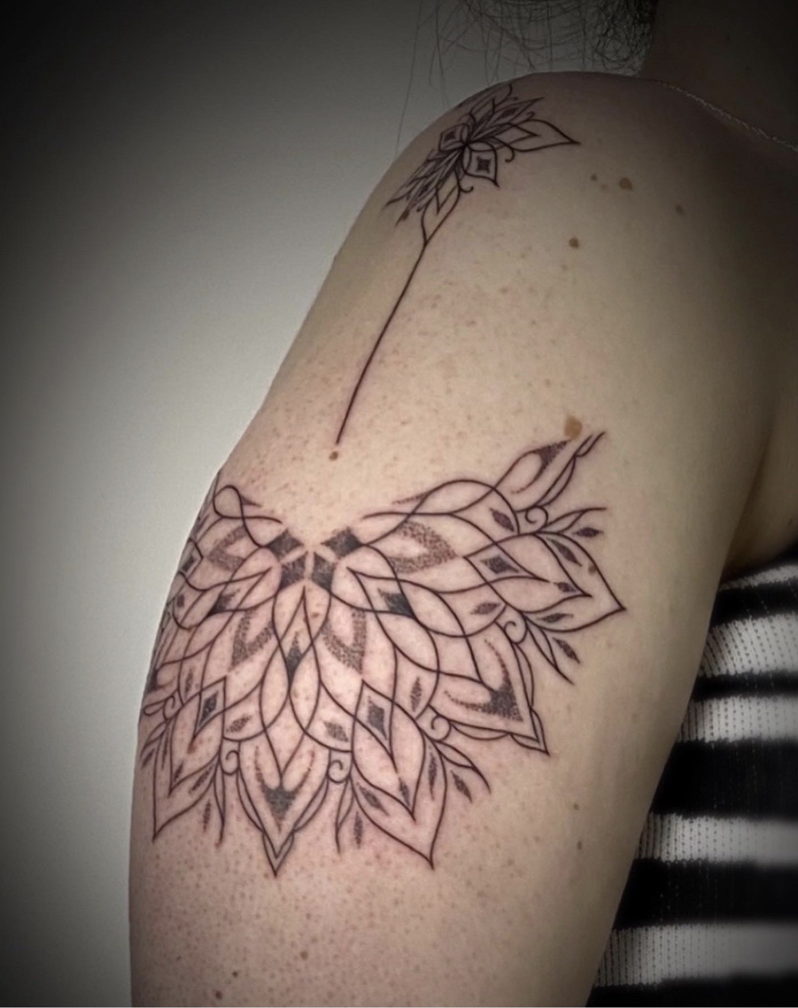 Halve mandala tattoo op schouder